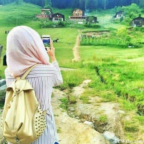 a woman taking a photo of a village dp for muslim girls