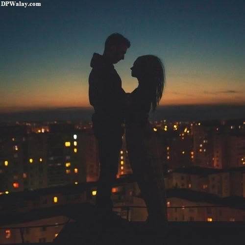 a couple kissing on the roof of a building at night images by DPwalay