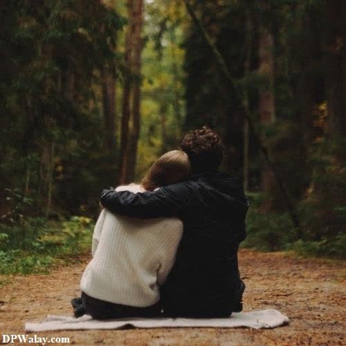 Romantic DP - a couple sitting on a blanket in the woods