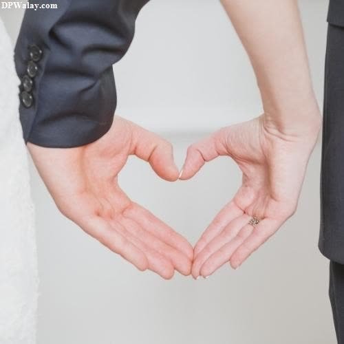 a bride and groom holding hands in the shape of a heart dp whatsapp romantic arjun reddy images 