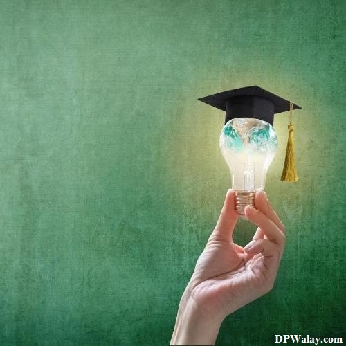 a hand holding a light bulb with a graduation cap on it exam time whatsapp dp