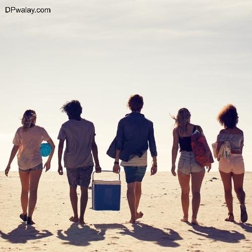a group of people walking on the beach