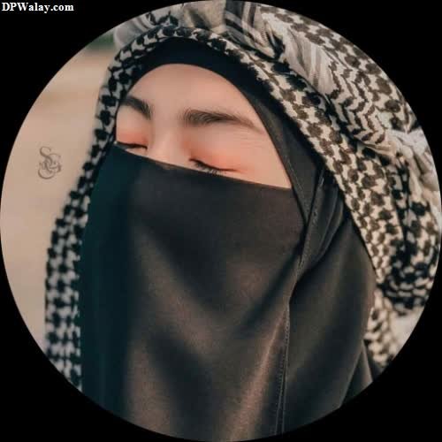 a woman wearing a black and white hina girl hijab dp