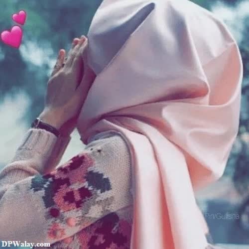 Hijab Girl DP - a woman in a pink scarf and a pink hat