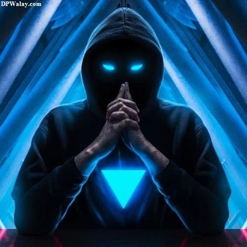 a man in a black hoodie with his hands clasped over his face, with a blue light