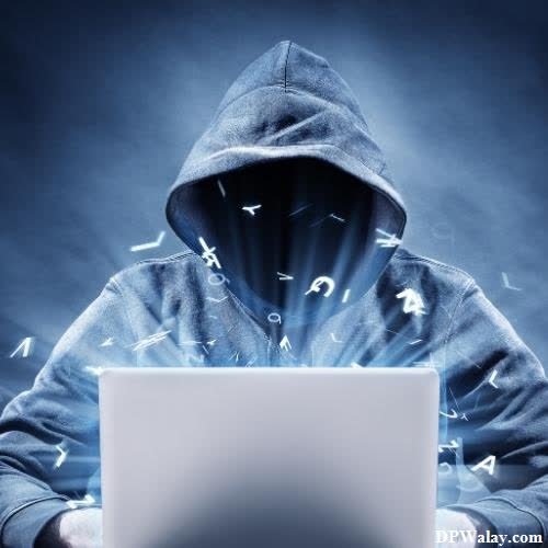 a person in a hoodie using a laptop