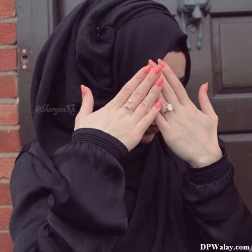 a woman in a black hoodie is praying images by DPwalay