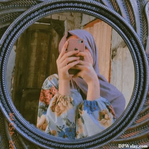 a woman taking a picture of herself in a mirror hijab dp for girls 