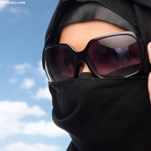 a woman wearing a black hood and sunglasses