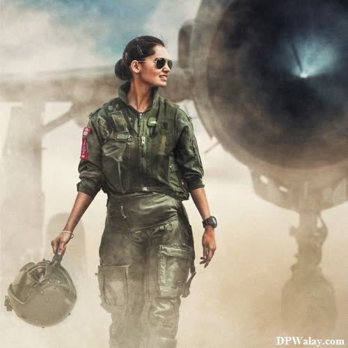 a woman in military gear walking towards a helicopter