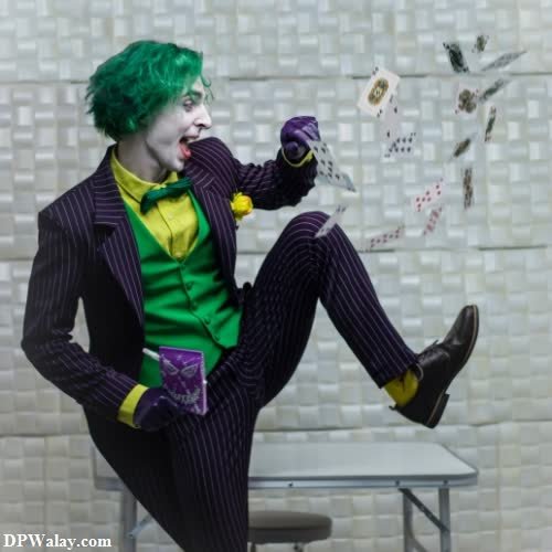 a man dressed as a joker sitting on a chair