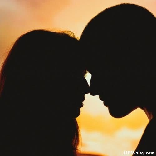 silhouette of a couple kissing at sunset