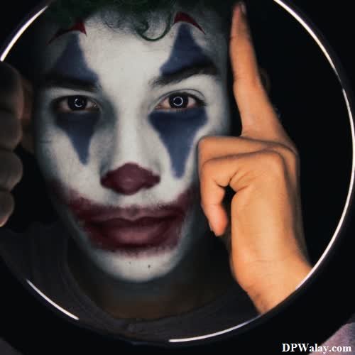 a man with a clown makeup looks into a mirror
