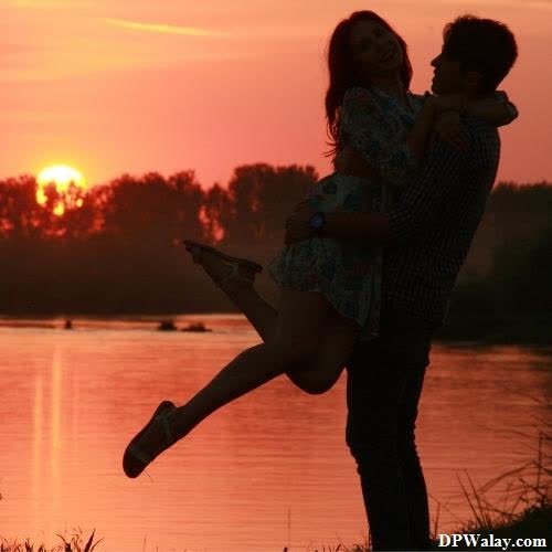 a man and woman are kissing in front of a sunset images by DPwalay
