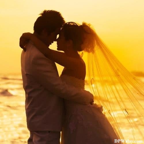 Modern Cute Couple DP - a bride and groom kissing on the beach at sunset
