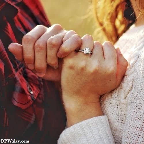 Modern Cute Couple DP - a couple holding hands while standing in a field