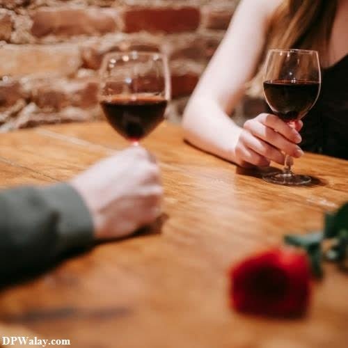 a man and woman sitting at a table with wine glasses modern cute love couple whatsapp dp 