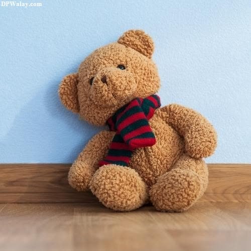 a teddy bear sitting on a wooden floor