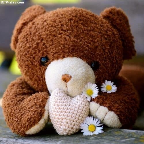 a teddy bear with a flower in its mouth pink teddy bear dp 