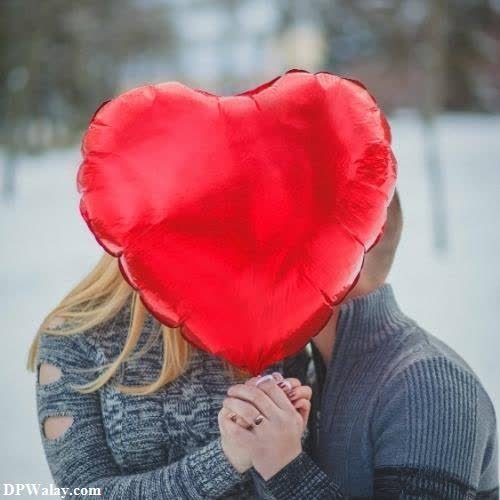 a woman holding a red heart shaped pillow romantic bengali caption for fb dp 