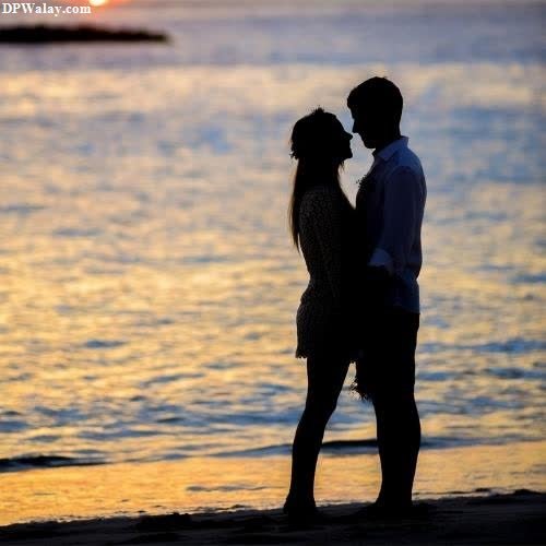 a couple kissing on the beach at sunset-OVnY romantic couple pic for dp