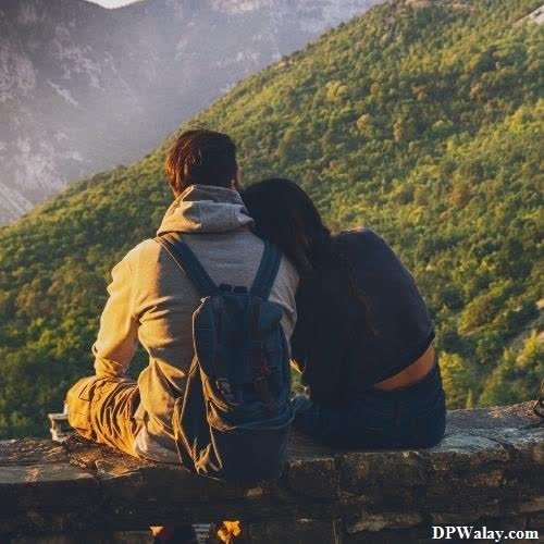 a couple sitting on a rock looking at the mountains romantic couple pic for dp 