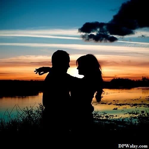 a couple is silhouetted against a sunset romantic dp