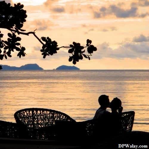 a couple sitting on a bench in front of the ocean romantic dp for instagram