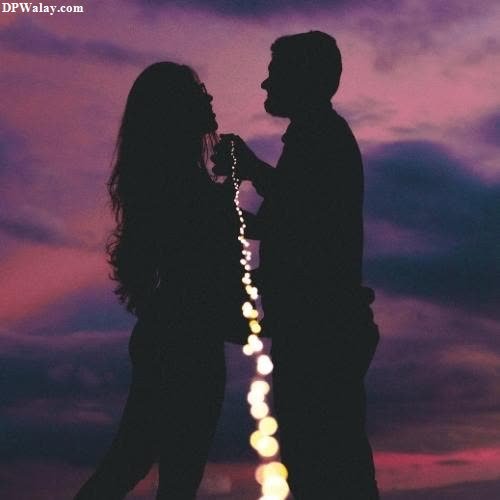 a couple standing in the sunset with their arms around each other couple romantic dp for whatsapp