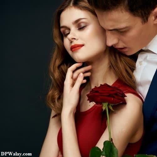 a man and woman are holding a rose romantic dp pic