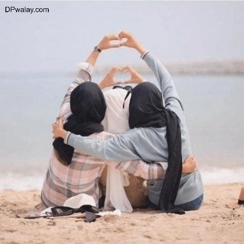 a couple sitting on the beach with their arms around each other couple 