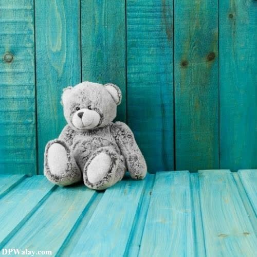 a teddy bear sitting on a blue wooden table teddy bear images for dp 