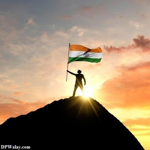a man holding the indian flag on top of a mountain images by DPwalay