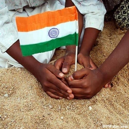 a child holding a flag in the sand