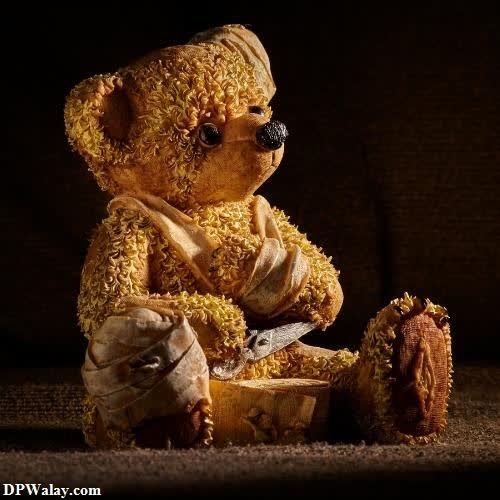 a teddy bear sitting on a wooden stump