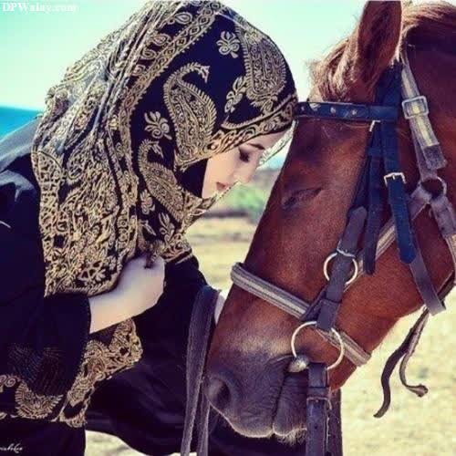 a woman in a black dress is petting a horse whatsapp dp for muslim girl