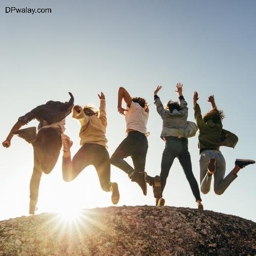 a group of people jumping on top of a mountain whatsapp school friends group dp