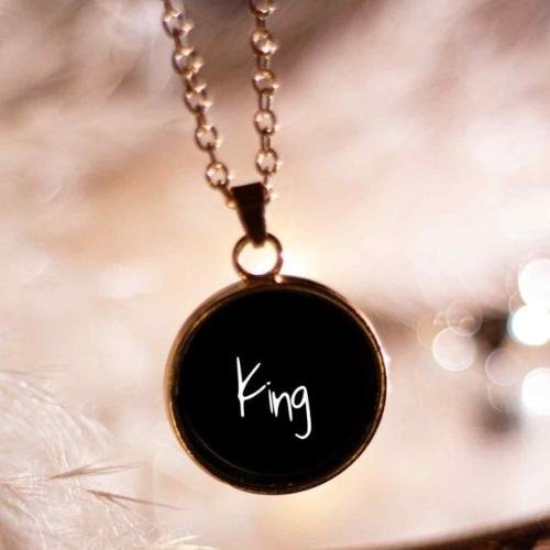 a black necklace with the word king written on it