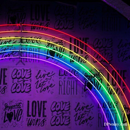 a neon sign with the words love and a rainbow