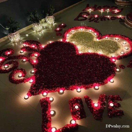 aesthetic dp - a heart shaped flower arrangement with candles and flowers