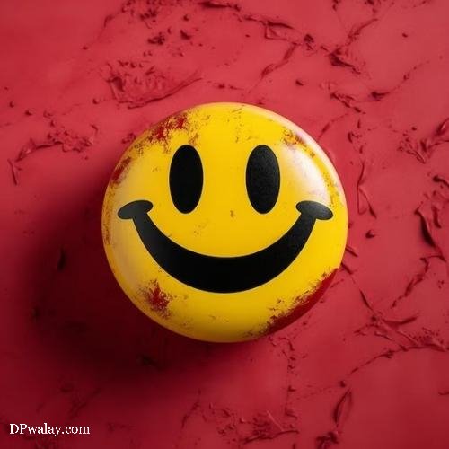 a smiley face ball on a red surface