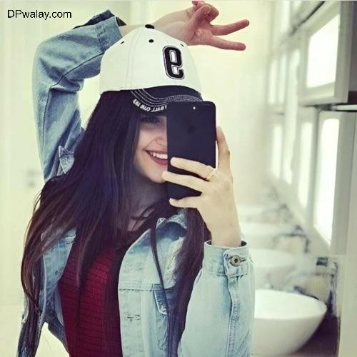 a woman wearing a hat and jacket cool whatsapp dp for girls