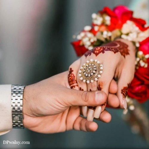couple holding hands with red flowers images by DPwalay