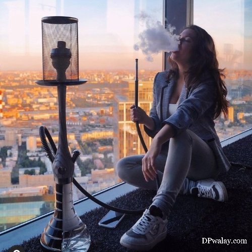 woman sitting on window sing cigarette