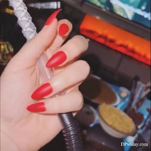 woman with red nails holding microphone smoking dp