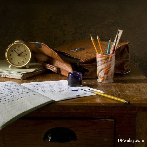 desk with clock, books and pen