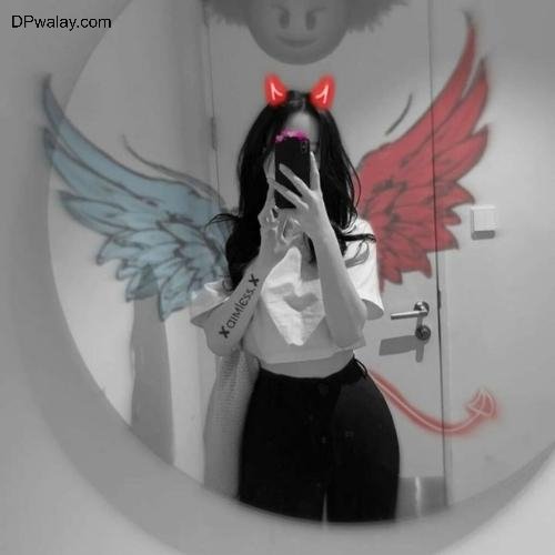 girl with wings on her face is reflected in mirror
