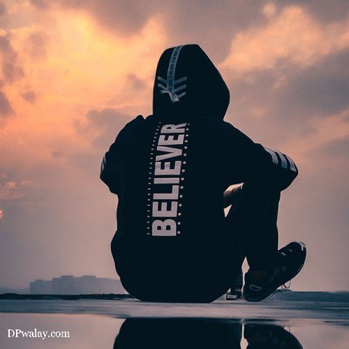 person sitting on roof with the words believe