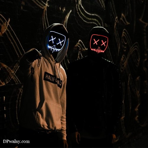two people wearing masks in dark room