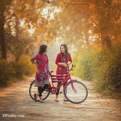 two girls on bike in the woods